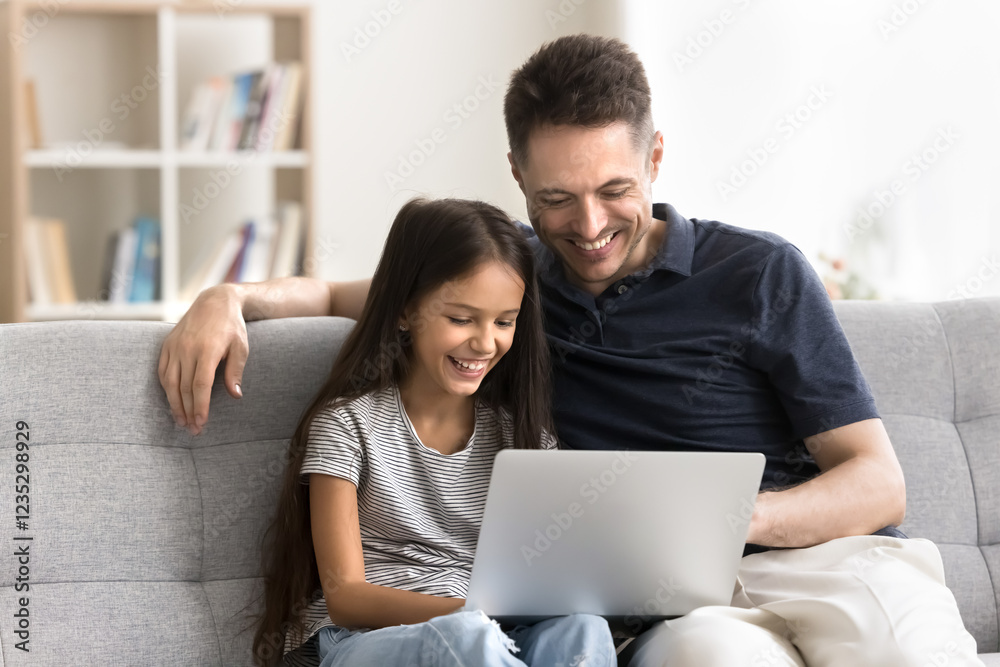 Happy single parent foster dad and tween age child adopted daughter enjoy spending free time together using laptop. Young man babysitter and little girl watch video at social media surf websites on pc Happy single parent foster dad and tween age child adopted daughter enjoy spending free time together using laptop. Young man babysitter and little girl watch video at social media surf websites on pc