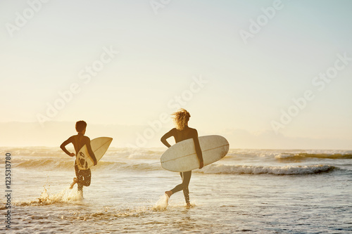 Photography Beach, surfboard and men running, sunset and water sports in fun, healthy lifestyle or fitness