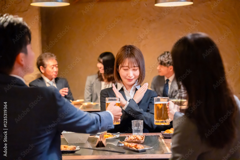 居酒屋で新入社員の歓迎会をするビジネスパーソン