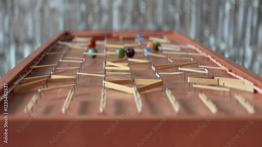 Handmade marble racing game with rubber band obstacles Handmade marble racing game with rubber band obstacles