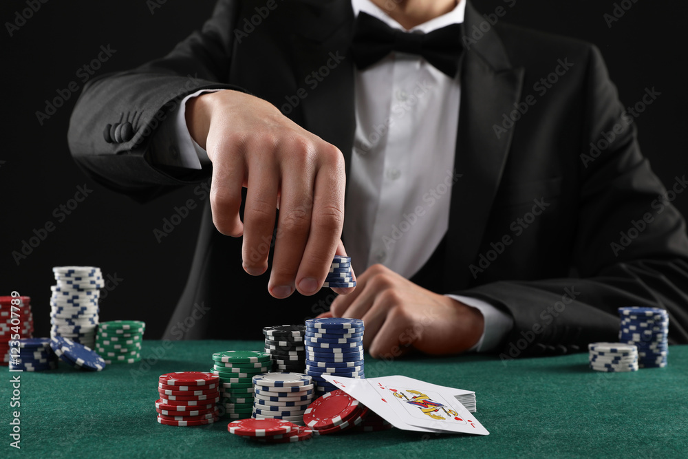 Man with cards and casino chips playing poker at gambling table, closeup Man with cards and casino chips playing poker at gambling table, closeup