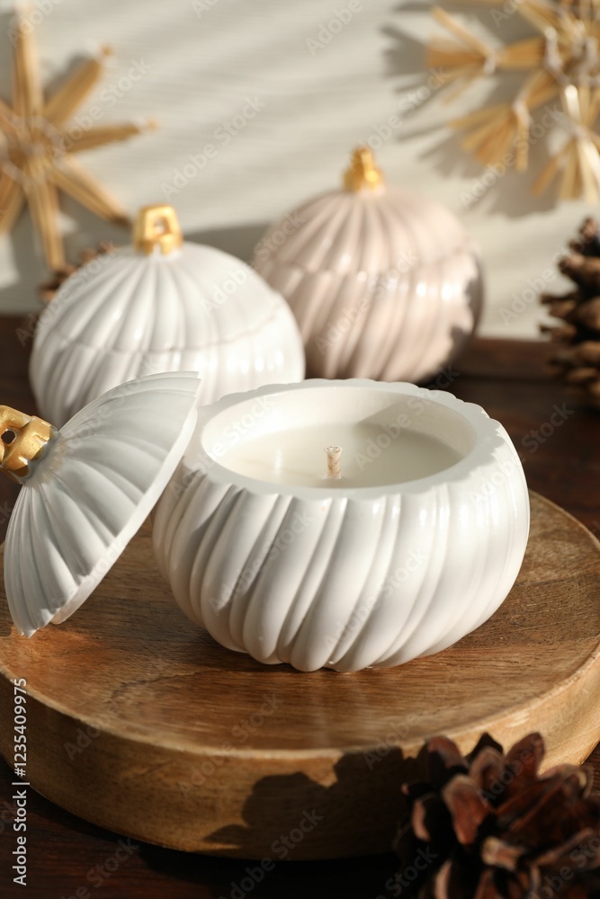 Soy wax candles and cones on wooden table. Beautiful christmas decor Soy wax candles and cones on wooden table. Beautiful christmas decor