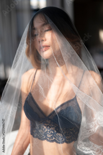 Asian model portrait in bedroom studio.