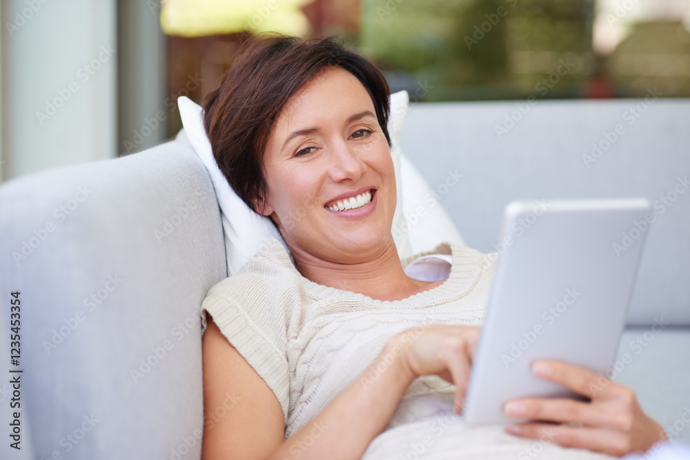 Sofa, portrait and woman with tablet for ebook, online entertainment and web subscription at home. House, female person and relax with smile for interactive app, social media and game in living room Sofa, portrait and woman with tablet for ebook, online entertainment and web subscription at home. House, female person and relax with smile for interactive app, social media and game in living room