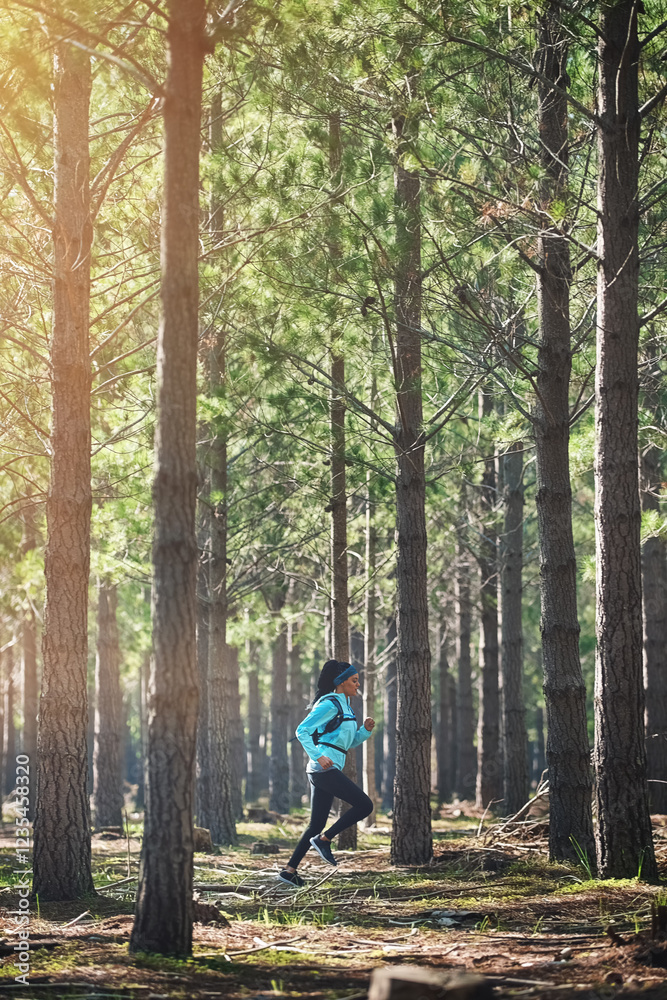Trail, running and woman in woods with fitness, trees and health challenge on morning workout. Nature, exercise and girl runner in forest for outdoor marathon, endurance training and wellness in park Trail, running and woman in woods with fitness, trees and health challenge on morning workout. Nature, exercise and girl runner in forest for outdoor marathon, endurance training and wellness in park