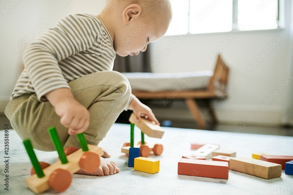 Child, playing and baby building blocks in home bedroom for fun and growth development. Male toddler kid with wooden car toys for learning, education or game for creativity and motor skills