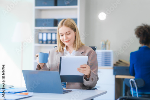 A young Russian woman in formal suit works diligently in business office, analyzing financial charts, using a desktop PC, calculator while contributing to various business strategies and projects.