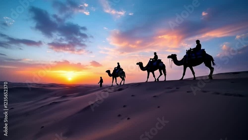 Sunset Silhouette of Camel Caravan Crossing Desert Dunes