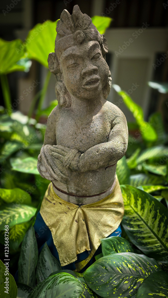 Obraz premium Garden Gnome traditional stone statue situated in a tranquil tropical garden, surrounded by vibrant foliage and artistic decor, harmonizing with the natural beauty of its environment