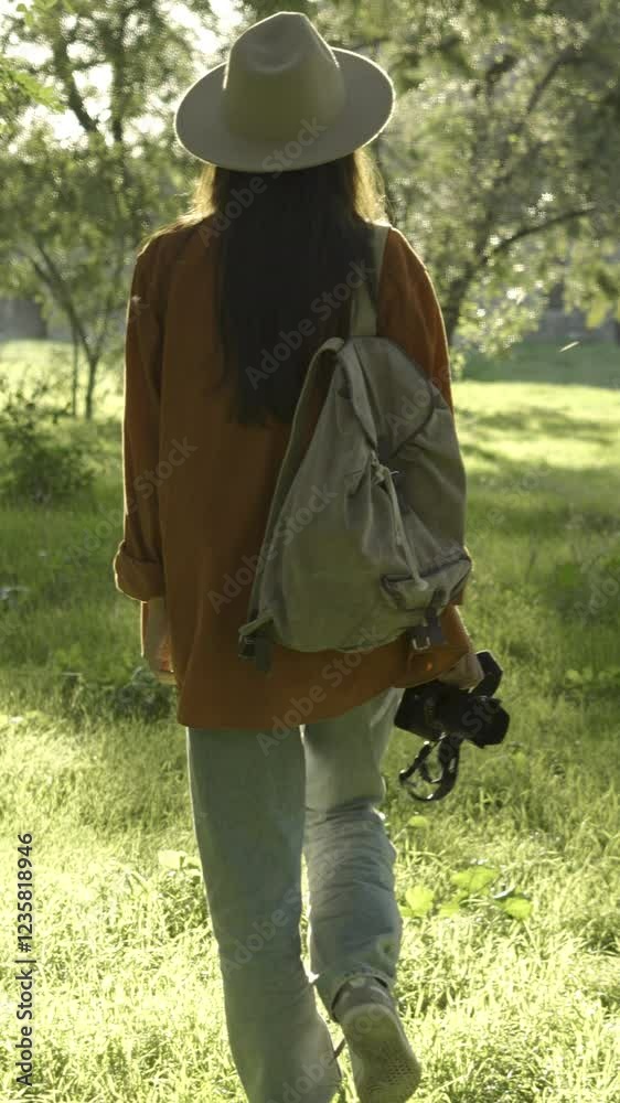 traveler with camera exploring park with retro backpack traveler with camera exploring park with retro backpack