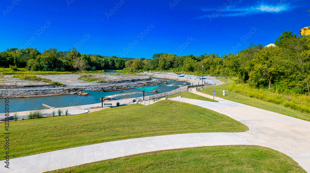 Fototapeta premium Scenic Riverside Park with Walking Paths