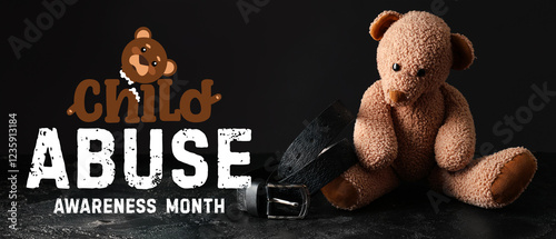 Toy bear with belt on dark ...