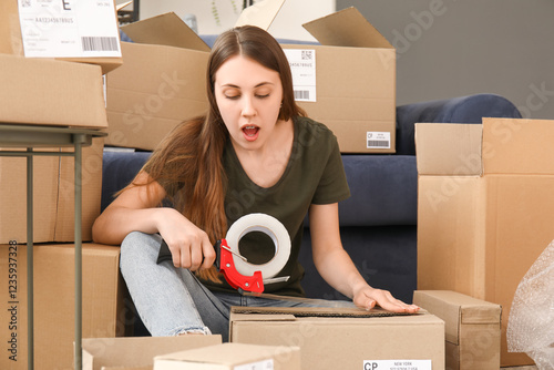 Shocked young woman taping ...