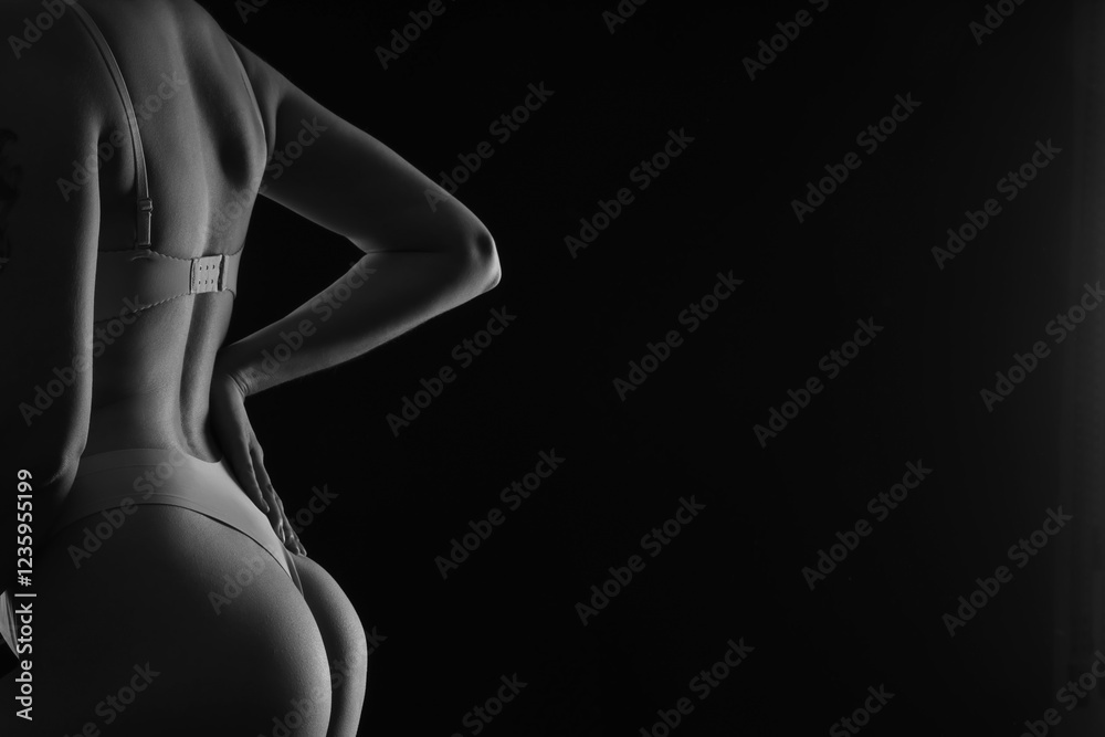 Naklejka premium Silhouette of attractive young woman in underwear on dark background, closeup