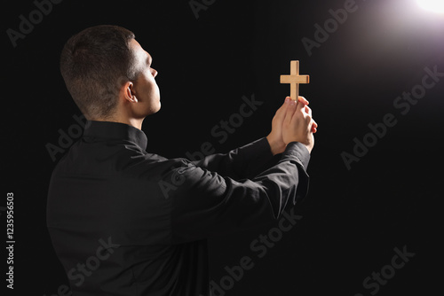 Young priest with cross on ...