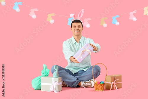 Happy young man in bunny ea...