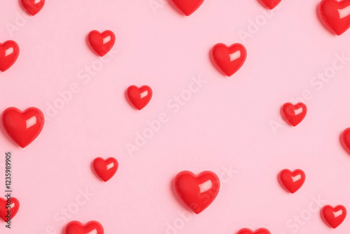 repeating pattern of bright red hearts on smooth light pink background