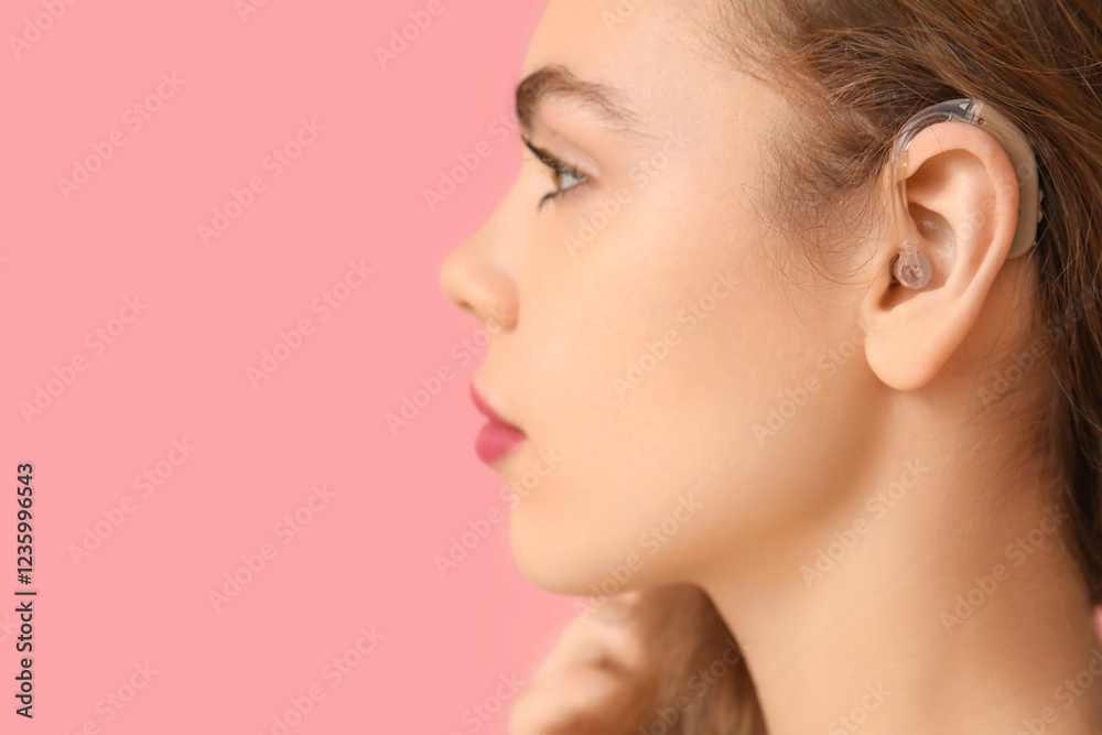 Beautiful young woman with hearing aid on pink background, closeup Beautiful young woman with hearing aid on pink background, closeup