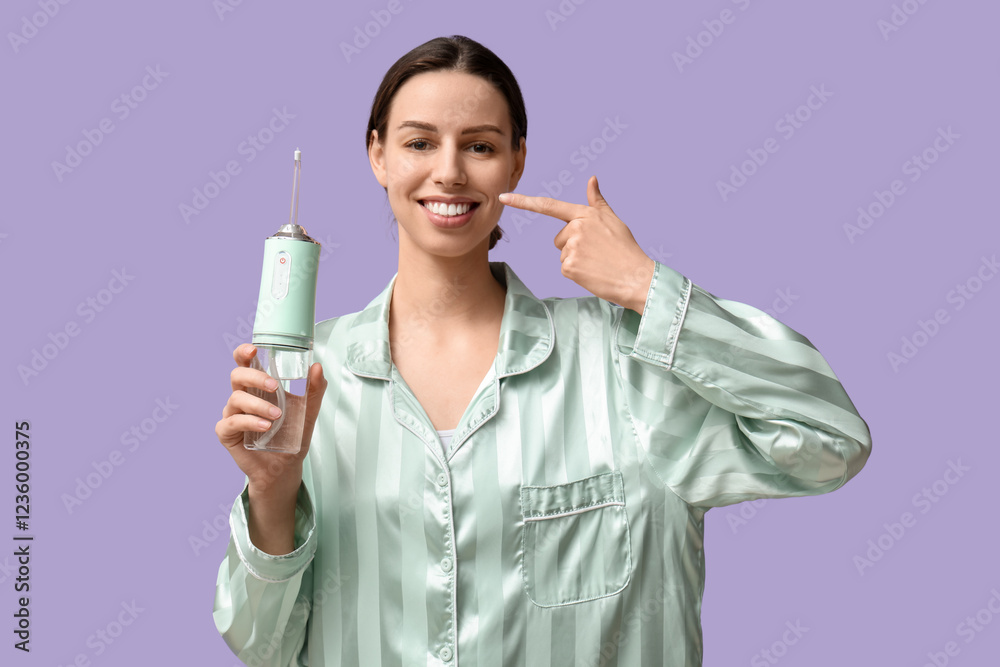 Beautiful young woman with oral irrigator on lilac background Beautiful young woman with oral irrigator on lilac background