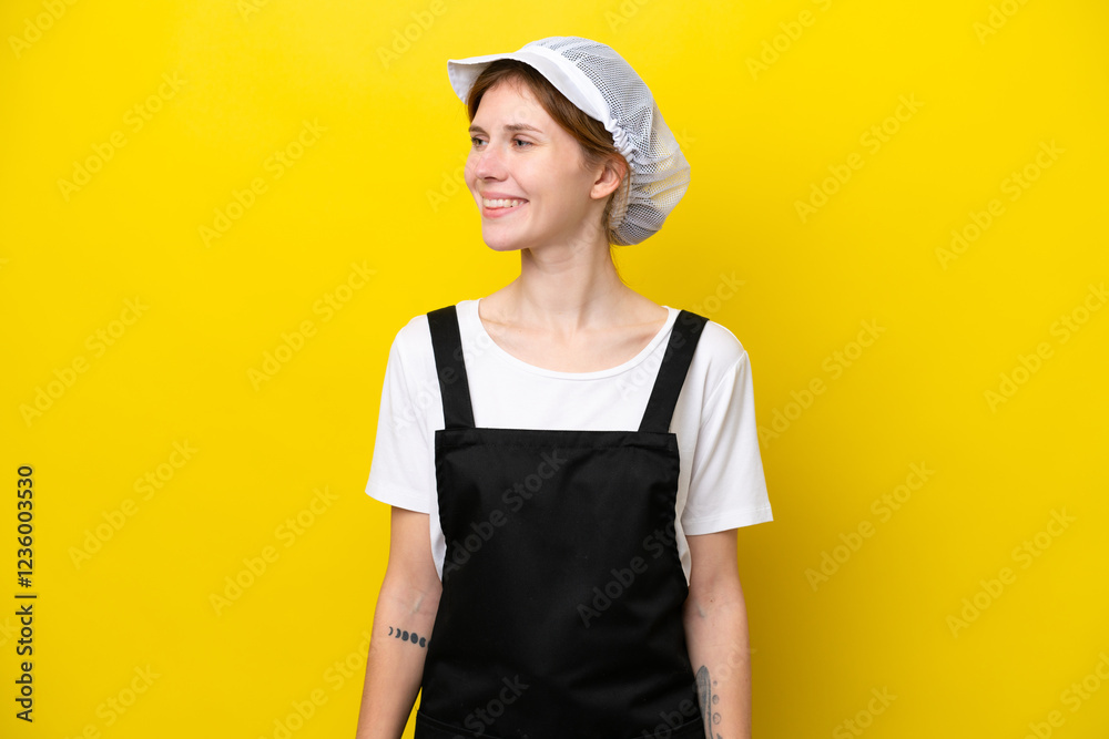 Young English fisherwoman isolated on yellow background looking side Young English fisherwoman isolated on yellow background looking side