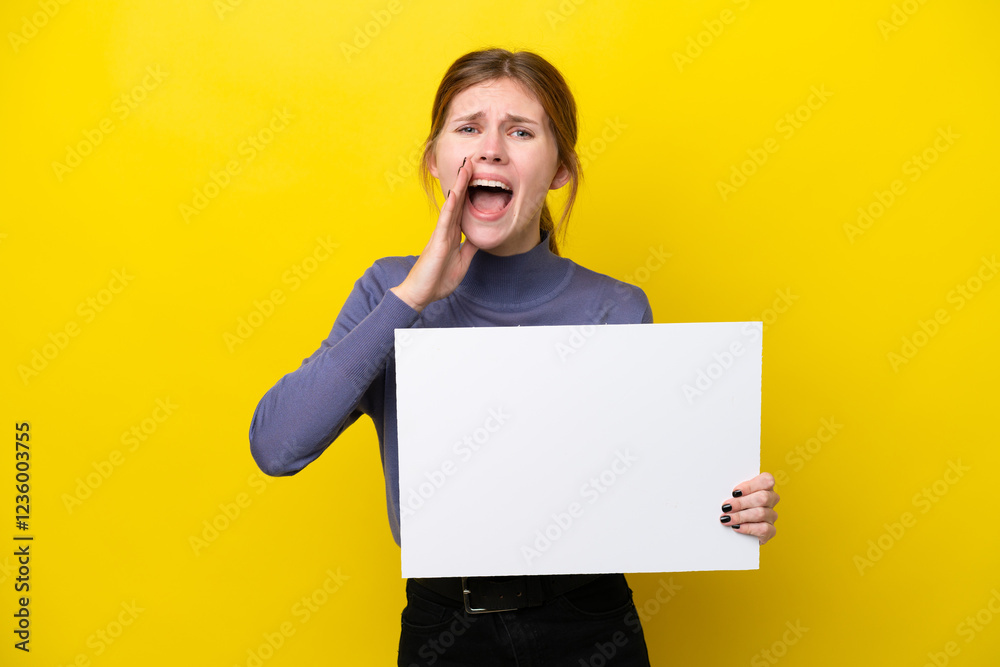Young English woman isolated on yellow background holding an empty placard and shouting Young English woman isolated on yellow background holding an empty placard and shouting