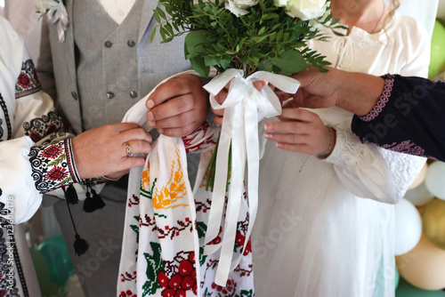 According to the Ukrainian tradition, parents tie the hands of the newlyweds with a vyshyvanka. photo