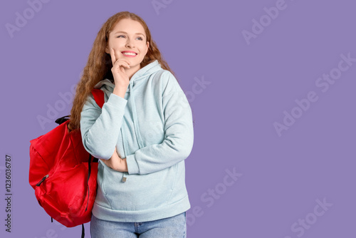 Happy female student with b...