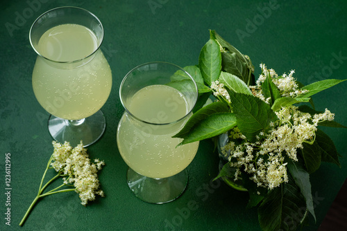 Carbonated elderflower drink. Flower summer kvass in glasses. Sparkling homemade hugo water. Green fresh drinks