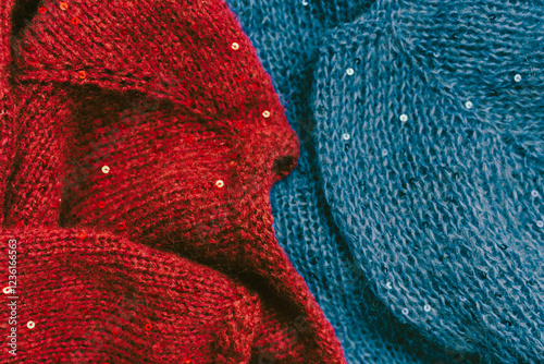 Obraz na płótnie Red and blue knitted sweater with sequins. Sequinned knitwear. Sequin pattern in needlework. Knitting hobby. Knitter work. Sequins texture in knitwear. Bright knitted fashion for holidays. w salonie
