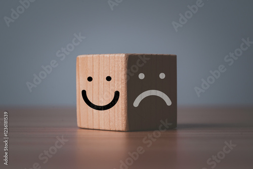 Smile face on bright of block and sad dace on dark of block for mental health and emotional mindset concept