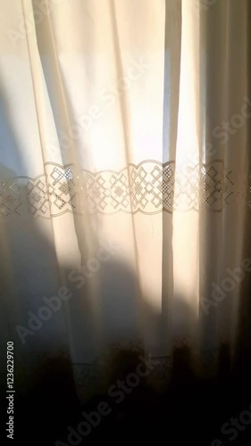 Sunlight gently filters through a translucent white curtain, casting a radiant star-like glow. The serene atmosphere evokes hope, tranquility, and the promise of a peaceful day ahead