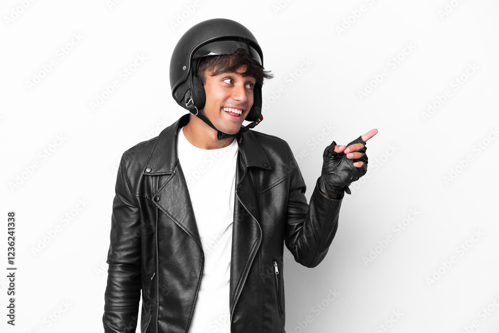 Young man with a motorcycle helmet isolated on white background intending to realizes the solution while lifting a finger up Young man with a motorcycle helmet isolated on white background intending to realizes the solution while lifting a finger up