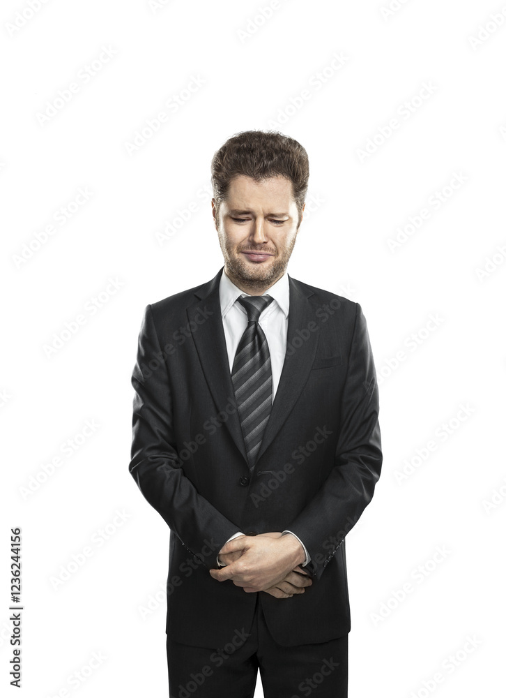 Man in formal attire with a suit and striped tie, standing with hands clasped and a distressed facial expression. Isolated on a white background Man in formal attire with a suit and striped tie, standing with hands clasped and a distressed facial expression. Isolated on a white background