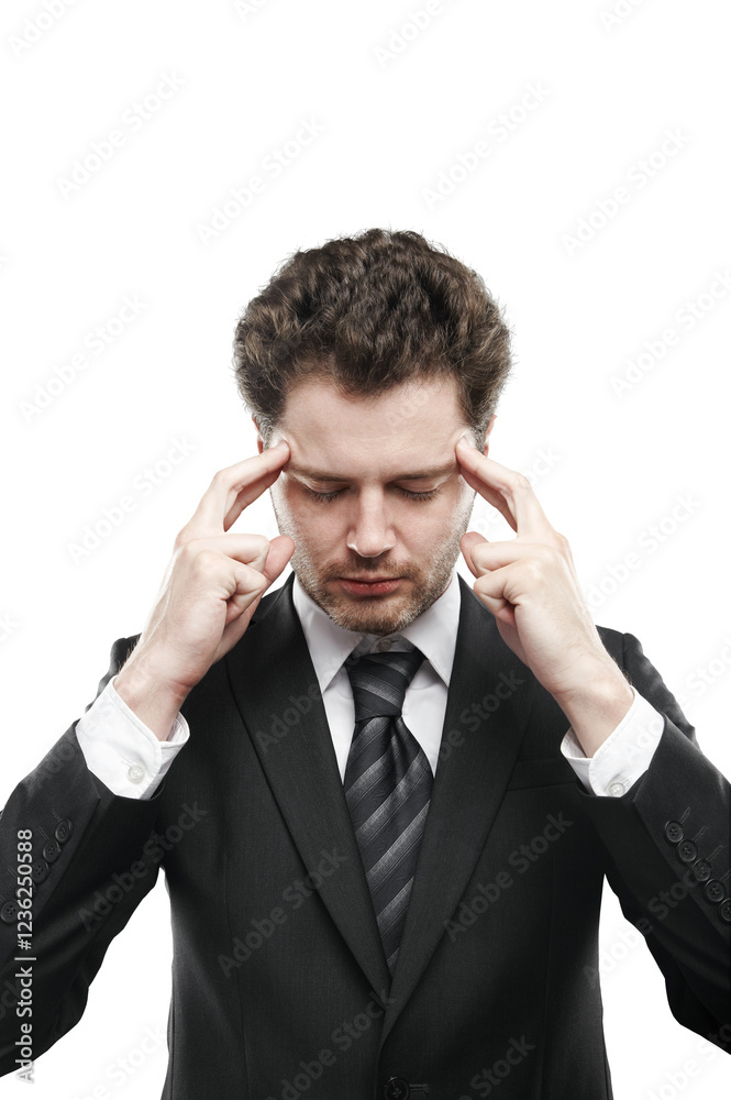 Focused businessman in formal suit touching temples, isolated on white background. Concept of stress, concentration, or decision-making Focused businessman in formal suit touching temples, isolated on white background. Concept of stress, concentration, or decision-making