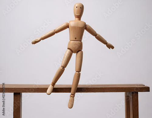 wooden mannequin jumping from a bridge