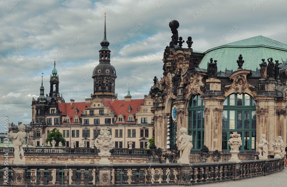 Obraz premium A breathtaking view of Dresden’s historic skyline from the Zwinger Palace. The intricate Baroque details, statues, and red-roofed castle create a perfect blend of art, history, and architecture.