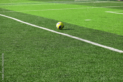 ball on artificial green grass, playground for soccer photo