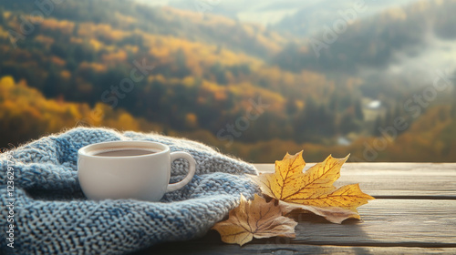 White mug with a drink surrounded by a crocheted cloth on view of mountains