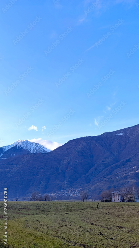 Fototapeta premium Beautiful mountains against a blue sky. Vertical image of majestic mountains.
