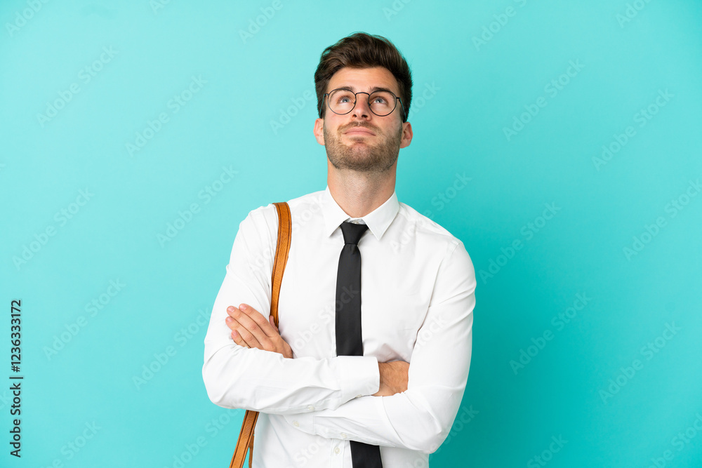 Business man over isolated background looking up while smiling Business man over isolated background looking up while smiling