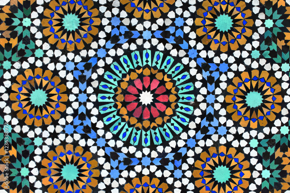 A detailed Islamic geometric mosaic featuring vibrant colors and symmetrical patterns. The design showcases traditional arabesque motifs with star shapes and interwoven lines