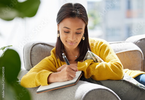 Woman, relax and writing in journal at house for diary entry, personal growth and wellness affirmations. Female person, book and creativity for goals reminder, inspiration quotes and gratitude letter