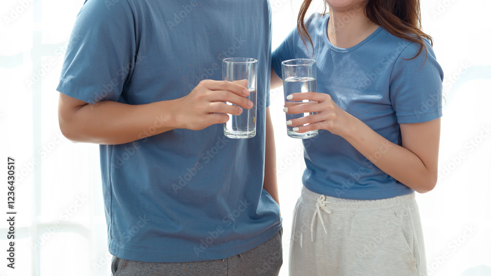 Happy Couple Enjoying Refreshing Drinks Together in Bright Indoor Space During Daytime Happy Couple Enjoying Refreshing Drinks Together in Bright Indoor Space During Daytime