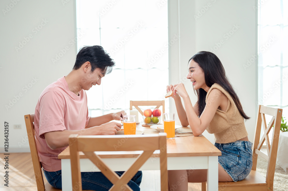 Couple Enjoys a Cheerful Breakfast at a Bright, Modern Dining Table in a Cozy Home Setting Couple Enjoys a Cheerful Breakfast at a Bright, Modern Dining Table in a Cozy Home Setting