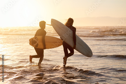 Photography Men, surfer friends and running at sunset beach for waves, freedom and swim from behind