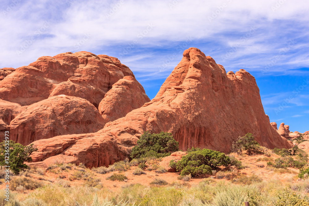 A rocky mountain range with a few trees in the foreground A rocky mountain range with a few trees in the foreground