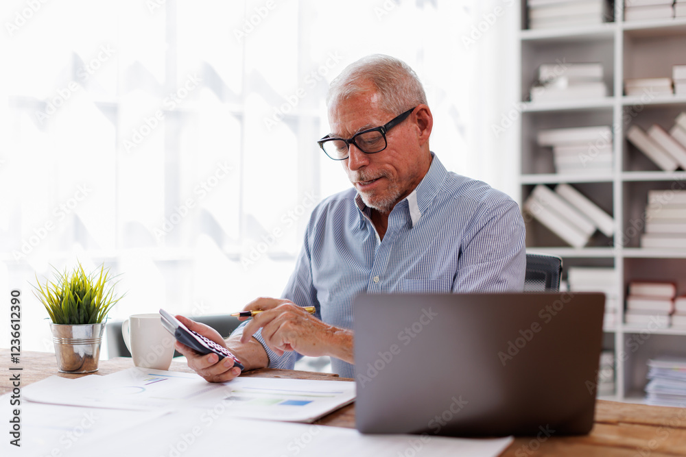 Mature Caucasian man working at office with documents on his desk, doing planning analyzing the financial report, business plan investment, finance analysis concept Mature Caucasian man working at office with documents on his desk, doing planning analyzing the financial report, business plan investment, finance analysis concept