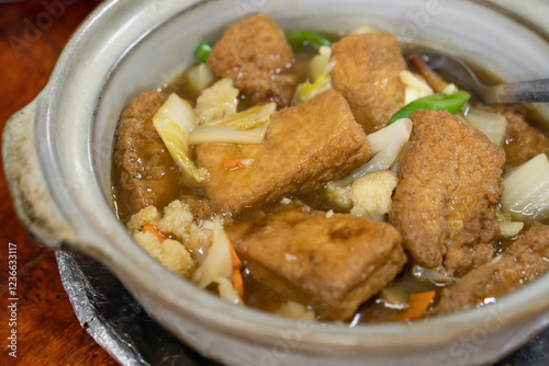 Closeup view of claypot tofu with vegetables.