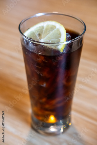 Wallpaper Mural A glass of Cola with a slice of lemon on the table Torontodigital.ca