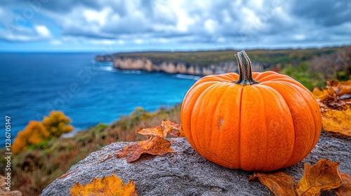 Autumn pumpkin by ocean cliff photo